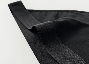 Macro shot of black cotton knit fabric showing edge detail and elastic texture