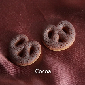 Detailed view of cocoa colored resin pretzel charms for DIY phone case crafts