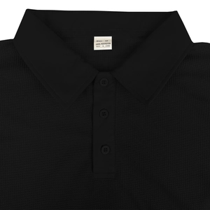 Macro shot of black men's polo shirt neckline showing waffle knit texture and buttons