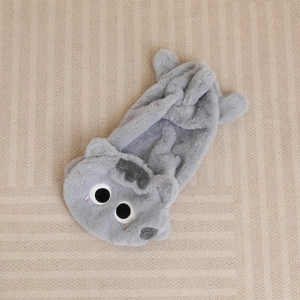 Close-up of soft grey plush cat shell featuring cute cartoon eyes and 3D ear details