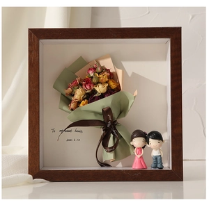 3D shadow box display with dried roses and couple figurines in a wooden grain frame