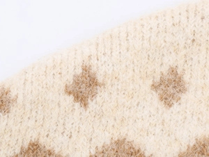 Macro view of beige and brown jacquard knit fabric with soft fuzzy mohair texture