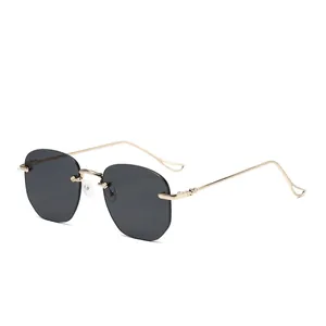 Fashionable rimless sunglasses with sharp dark grey lenses and golden metal temples
