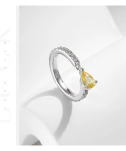 Macro shot of S925 sterling silver ring featuring a yellow pear-cut gemstone and S925 stamp