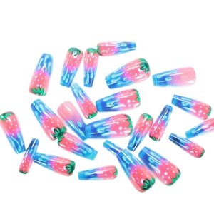Press-on nails in long coffin shape with pink strawberry and blue fluid drip patterns