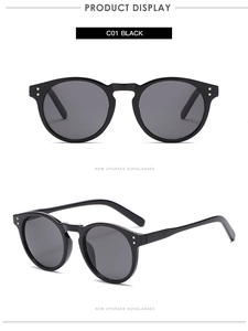 Close-up of black retro sunglasses with silver rivets and dark grey lenses in C01 finish