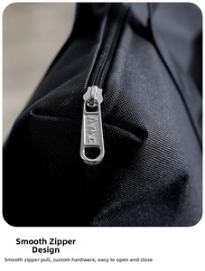 Close-up of smooth silver metal zipper on durable black canvas travel duffel bag detail
