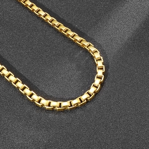 Close-up of a 7mm gold-plated stainless steel box chain necklace with a glossy finish
