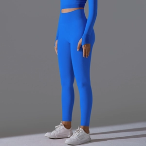 Detailed texture of seamless electric blue high-waisted yoga leggings and long sleeve top