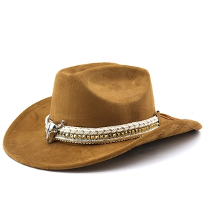 Detail of brown suede cowboy hat featuring a bull head metal buckle and braided rope