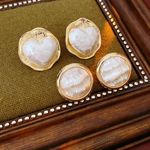 Détail des boucles d'oreilles plaquées or 16K en forme de cœur et rondes avec perles