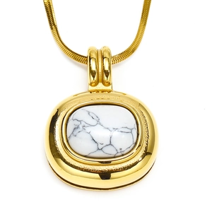 Close-up of retro 18k gold-plated snake chain necklace with oval white stone pendant