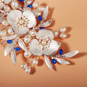Detail of silver bridal hair comb with pearls, rhinestones and blue beads floral design