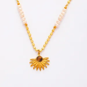 Detailed view of sunburst pendant with tiger eye stone and freshwater pearl beaded chain
