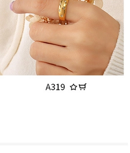 Detailed shot of a gold star pattern ring with small gemstones on a model's hand