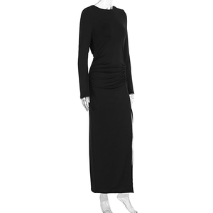 Detail of ruched waist design on a black slim fit maxi dress with elegant side slit
