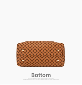 Detail view of the handbag bottom featuring four protective gold metal feet and monogram print