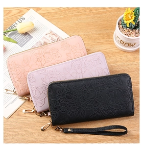 Detailed view of long zip wallets with 3D floral embossing in pink, lilac and black