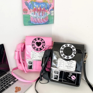 Detail of retro telephone crossbody bags in pink and black with Y2K aesthetic