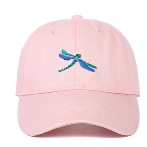 Pink cotton baseball cap with embroidered dragonfly design and curved brim visor