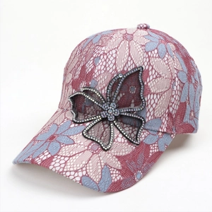 Detail of pink and blue lace flower pattern on cap with crystal butterfly ornament