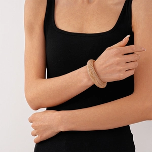 Close-up of amber acrylic spiral cuff bracelet on female wrist with retro textured design