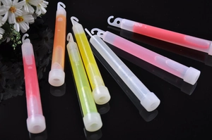 Detailed view of colorful 6-inch glow sticks with hooks on a black reflective surface