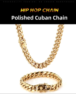 Detailed close-up of polished gold Cuban link chain set with double safety clasps
