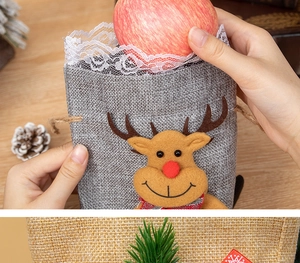 Detail of grey linen Christmas gift bag with 3D reindeer decor and white lace trim