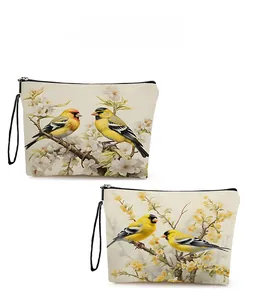 Detail view of bird and flower print on canvas makeup bags with zip and strap