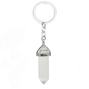 Detailed close-up of a clear crystal quartz hexagonal pendant on a metal keychain