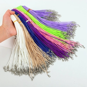 Close-up of colorful wax cord necklaces featuring metal lobster clasps and extension chains