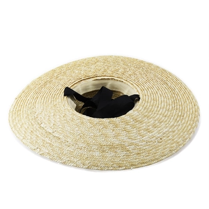 Elegant wide brim straw sun hat with black ribbon detail for summer beach vacations