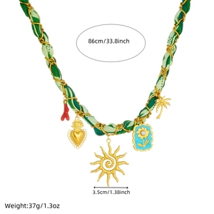 French retro gold sun and floral charm necklace with green ribbon and chain detail