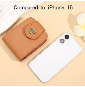 Brown leather card wallet with sunflower charm compared to iPhone 16 for size scale
