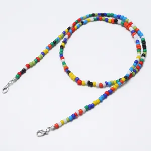 Detailed close-up of colorful beads strap with silver lobster clasps on white background