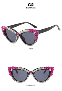 Macro detail of cat-eye sunglasses with pink rhinestones and white diamond studs