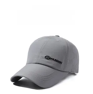 Detail of light grey baseball cap featuring SC FASHION embroidery and breathable fabric