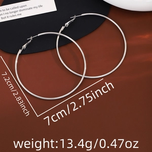 Detailed view of silver hoop earrings showing 7cm diameter and 13.4g weight