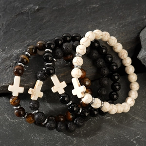 Detail of four beaded bracelets featuring white crosses with obsidian and tiger eye stones