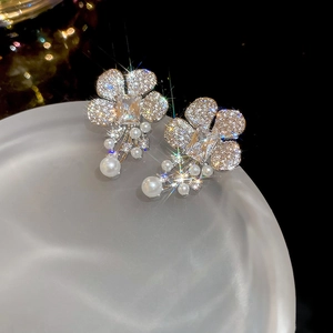 Exquisite flower stud earrings with shimmering zircons and dangling white pearls on black