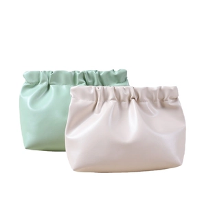 Portable PU leather squeeze coin purse in light green and beige for makeup storage