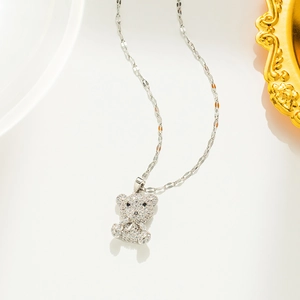 Macro detail of a silver teddy bear pendant with micro-inlaid sparkling rhinestones