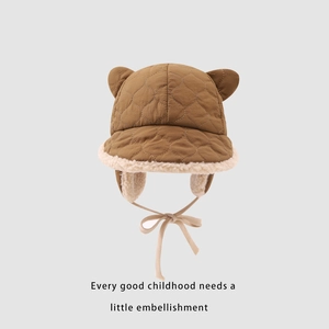 Detailed view of quilted winter baby earflap hat with soft fleece lining and cute ears