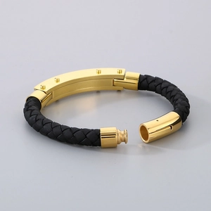 Detail of black braided leather bracelet for men featuring a gold magnetic clasp