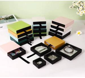 Detail of drawer-style jewelry gift boxes with floating PE film inserts in various colors