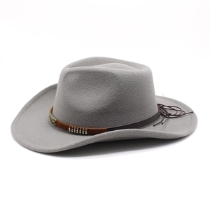 Detail of gray wool felt cowboy hat featuring brown leather band and metal ornaments
