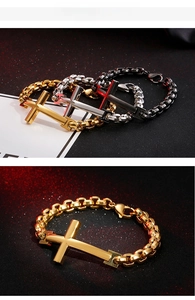 Macro detail of men's stainless steel cross bracelets in gold, silver, and black finishes