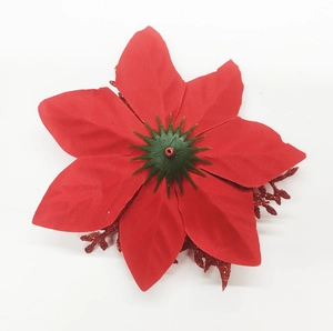 Detailed view of red artificial Christmas poinsettia with glittery petals for tree decor