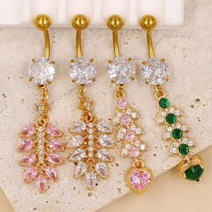 Detailed view of golden heart and leaf navel rings with pink and green zircon stones